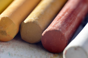 a set of pastels of different colors lies on the paper