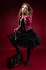 Girl, 1980's style with boom box and bubble gum. red backdrop