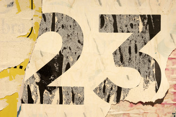 Old grunge ripped torn vintage collage posters creased crumpled paper surface placard texture background backdrop empty space for text number 23
