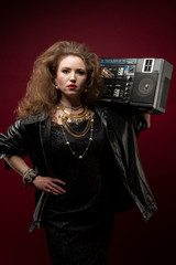 Girl with boom box, 1980's style. red backdrop.