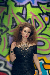 Girl 1980's style, graffiti wall.