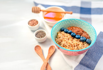 Buckwheat porridge in a bowl with flax seeds and blueberries. oncept healthy food, detox, diet, breakfast
