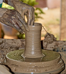 Potter busy making a pot. Potter works with clay by hands. Handmade terracotta pot. Craftsmanship. Close up