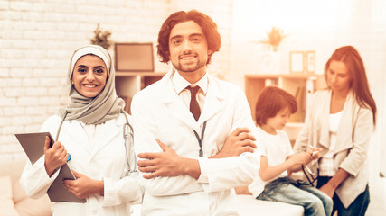 Fototapeta na wymiar Portrait of Smiling Arabic Doctors Pediatricians