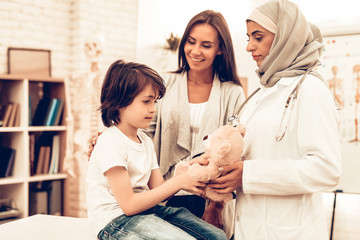 Arabic Doctor Giving Toy to Little Cute Patient