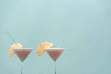 isolated Pineapple Cocktails on green background