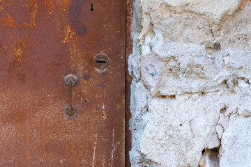 Very old iron door covered with rust.