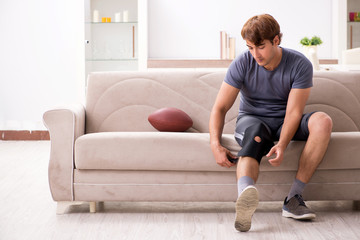 Injured man recovering at home from sports injury