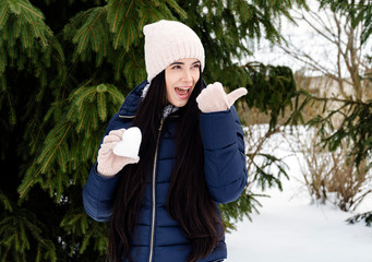 girl holds snow in the shape of a heart