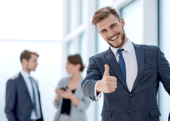 young businessman showing thumb up.