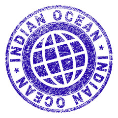 INDIAN OCEAN stamp imprint with grunge style. Blue vector rubber seal imprint of INDIAN OCEAN label with unclean texture. Seal has words arranged by circle and planet symbol.