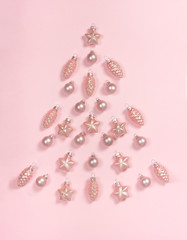 Christmas tree made of delicate pink baubles. Top view, flat lay style. Copy space for text.