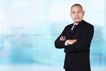 Young Bald Businessman Smiling at the Camera, Crossed Arm