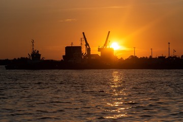 Fototapeta na wymiar Sunset in industrial port