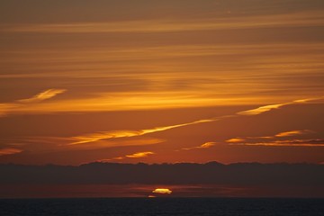 Obraz premium Sunset on the Gulf of Alaska, viewed from a cruise ship sailing west from Hoonah to Anchorage.