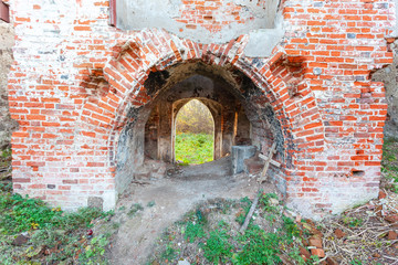 entrance to the ruins of an old medieval red brick church