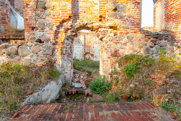entrance to the ruins of an old medieval red brick church