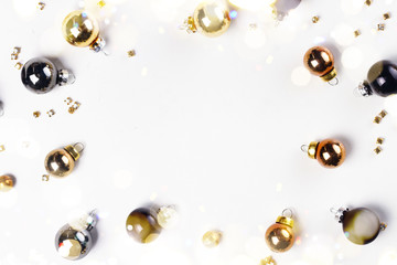 Christmas flat lay frame with golden, gray and black glass balls with copy space
