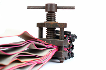 Retro metal screw press squeezes old computer cables. Data compression and information transmission...