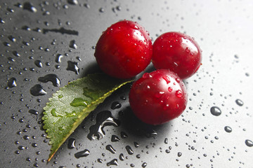Sweet ripe cherries. Fresh cherry on black background. Farming abundance