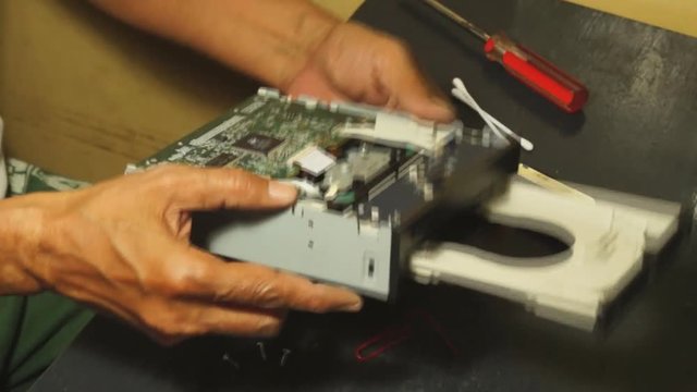 Technician prick pinhole of dvd drive tray to come out