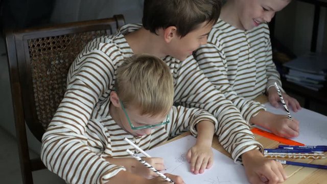 brothers draw together at the table