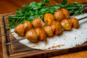 potatoes with fat tail on the grill
