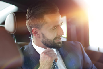Close-up of a successful businessman sitting in a comfortable car