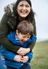 Cheerful mother embracing her son