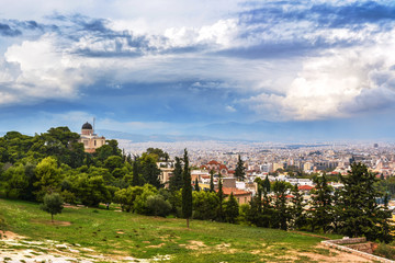 Fototapeta na wymiar Cityscape of Athens, church and houses from the hill