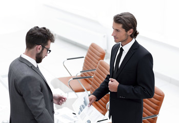 business partners discussing document