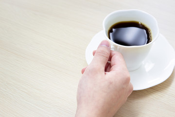 Black coffee in a white cup close up.