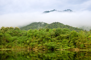 Beautiful landscape of peaceful lake and mountain in deep jungle in Thailand after the rain.