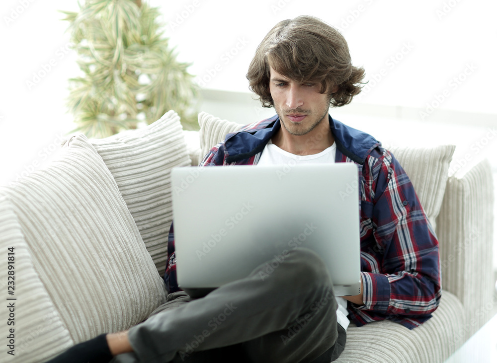 Wall mural very happy guy working with laptop at home.