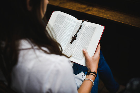 Woman reading from the Holy Bible - Powered by Adobe