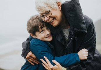 Happy grandmother hugging her grandson - Powered by Adobe