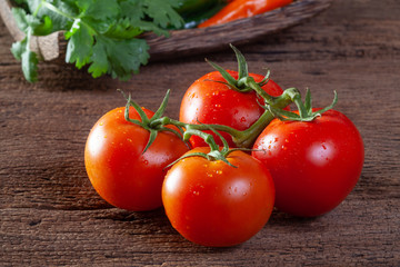 Fresh tomatoes on wooden background