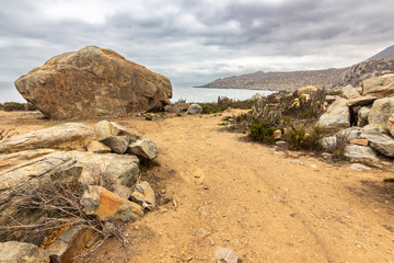 Totoralillo beach at Coquimbo region in north Chile at Atacama Desert is an amazing beach perfect for surf or rock climbing on its numerous rock boulders close to the Pacific Ocean with amazing views