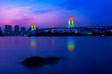 Colorful illuminations at Rainbow Bridge from Odaiba in Tokyo, Japan