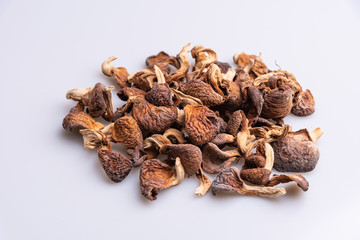 Dehydrated shimeji, dried mushrooms on white background, angle view, copy space, soft light