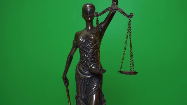 Themis statuette rotates on the background of chromakey