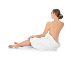 Fototapeta premium Young woman with soft towel sitting on white background