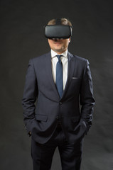 Man in black suit uses a virtual reality glasses.  VR 360. Virtual game