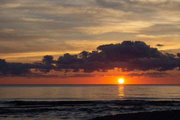 Sunset beneath clouds