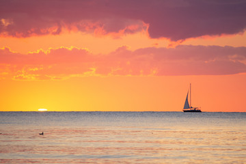 Fototapeta premium Yellow Sunset with Sailboat