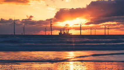 Wind Farm off the northern British Coast during golden sunrise