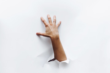 A hand breaks through the obstacle and tries to grab something greedily. Secret desire. Stealing....