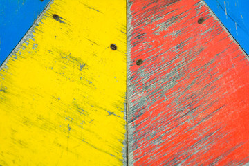 Naklejka premium Yellow, blue and red paint on old wooden background