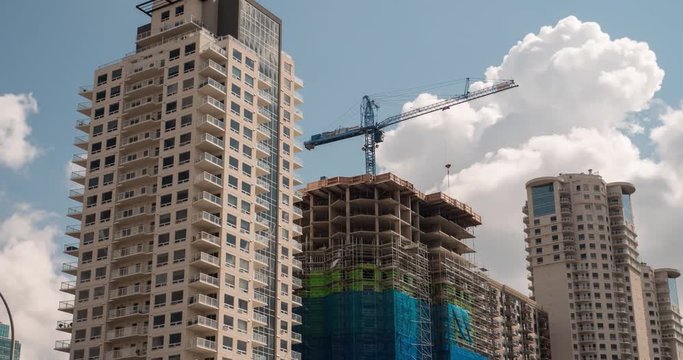 Time lapse of skyscraper under construction in downtown area of large city. 