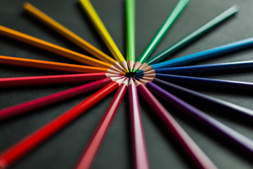 Colored pencils on black chalk board close-up